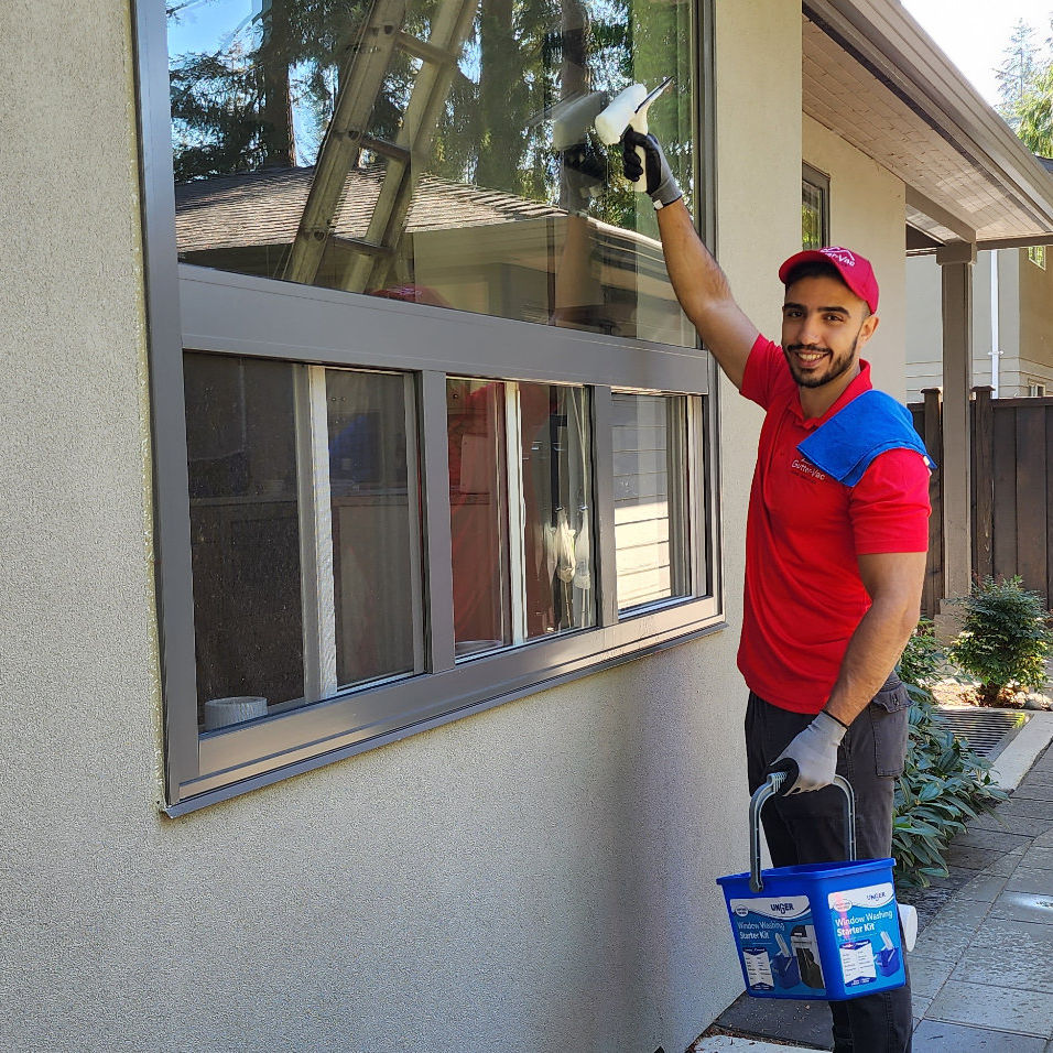 Guttervac team member washing exterior house window